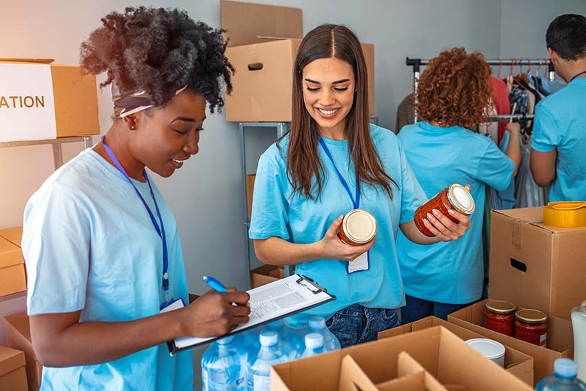 teenagers wearing blue shirts and volunteering at a food pantry
